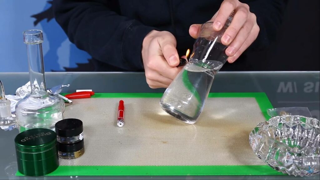 Burning a hole into a plastic bottle with a lighter