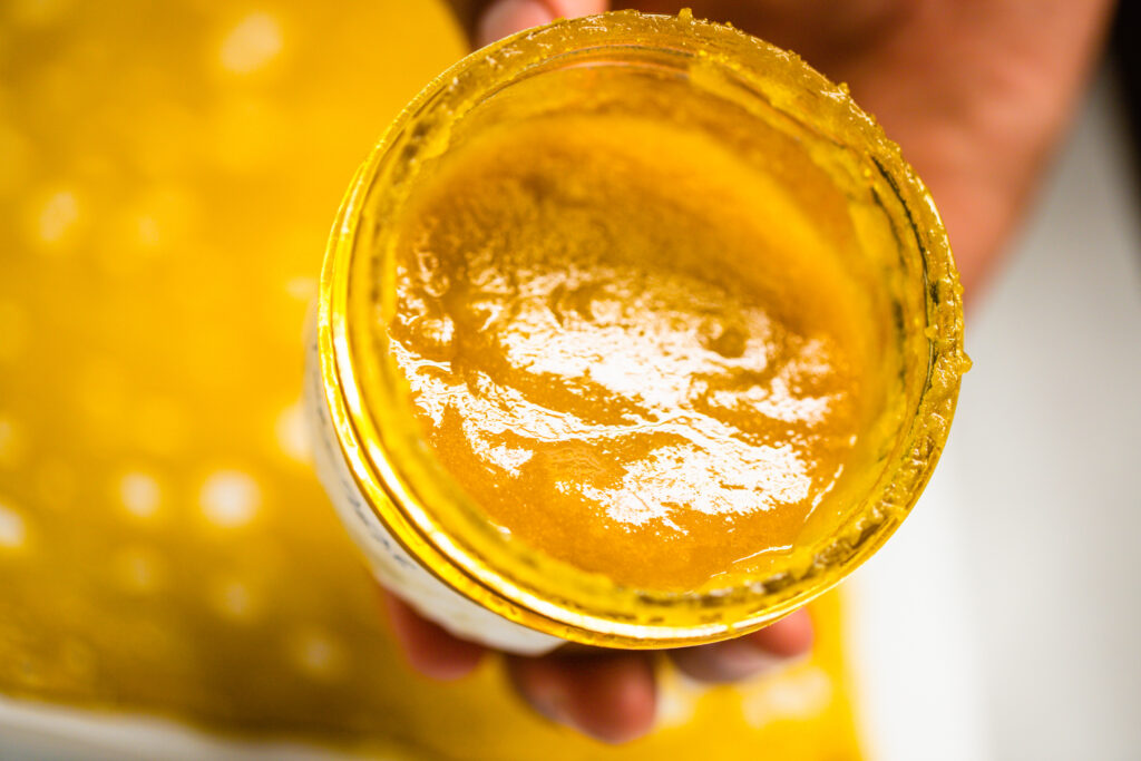 Premium cannabis extracts including live resin, rosin, bubble hash, wax, shatter, THC diamonds, and cannabis flower displayed on a dark surface with macro detail